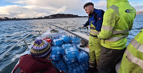 Storm Eowyn Easdale Workers on open boat to Easdale with repair kit and bottled water after storm Eowyn